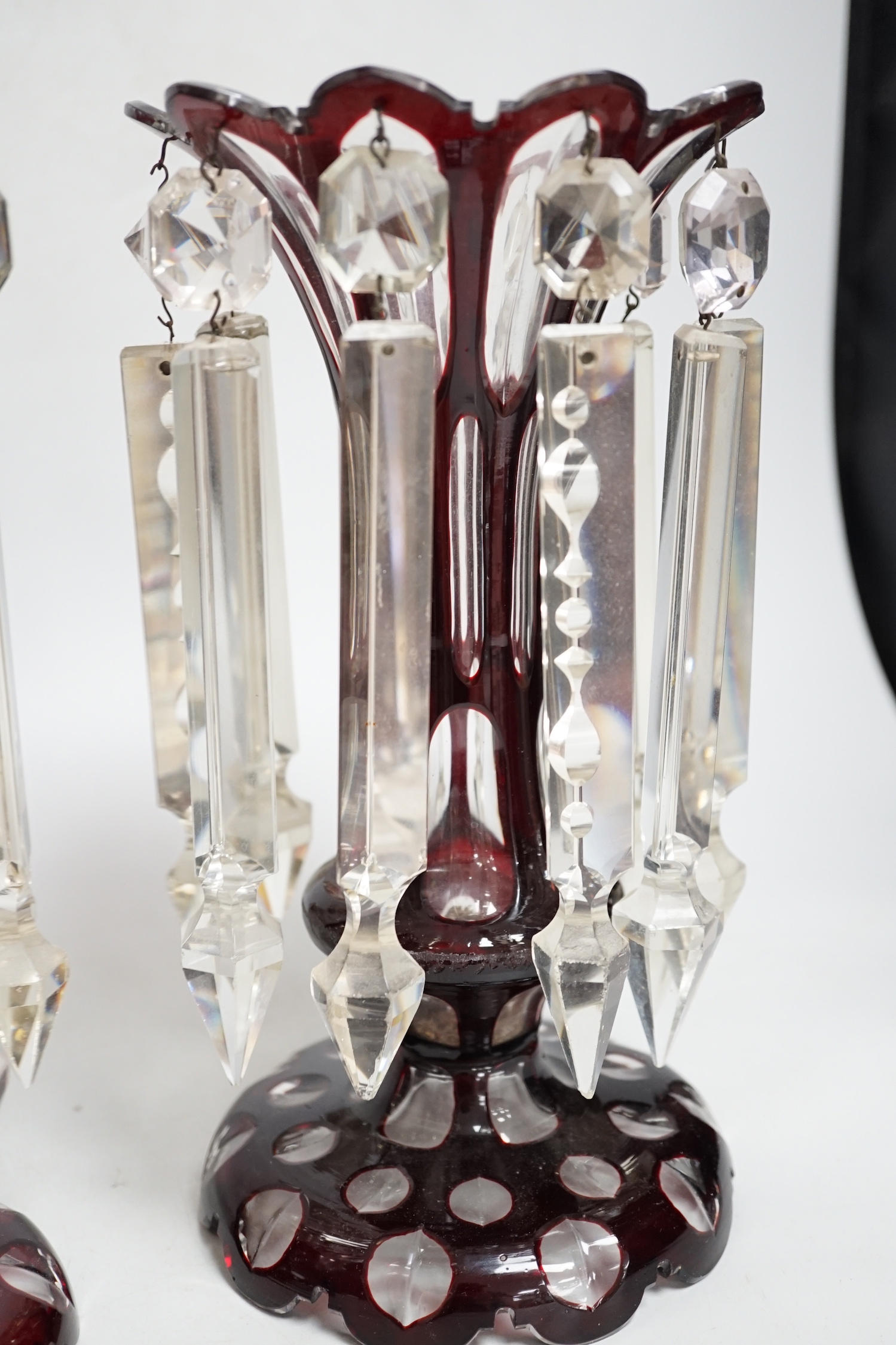 A pair of Victorian ruby overlaid glass table lustres, 28cm